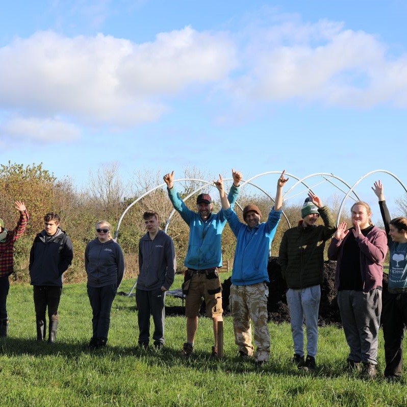 Growing Futures students cheering with arms in the air at Fentenfena Farm